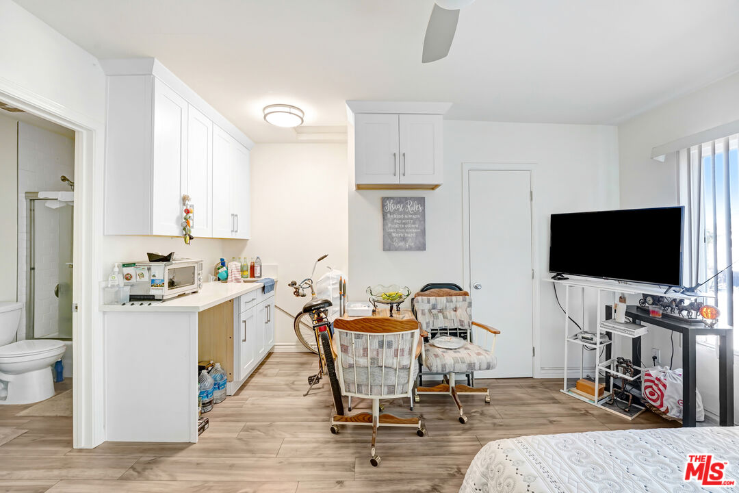 1740 Hauser Boulevard, Unit 8 Los Angeles, CA 90019 - Photo 8 of 10 a living room with furniture and a flat screen tv