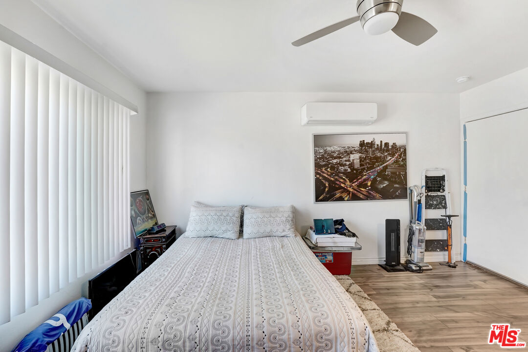 1740 Hauser Boulevard, Unit 8 Los Angeles, CA 90019 - Photo 9 of 10 a bedroom with a bed and a table