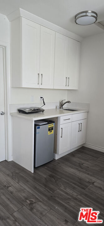 1740 Hauser Boulevard, Unit 8 Los Angeles, CA 90019 - Photo 10 of 10 a kitchen with stainless steel appliances granite countertop a sink and cabinets