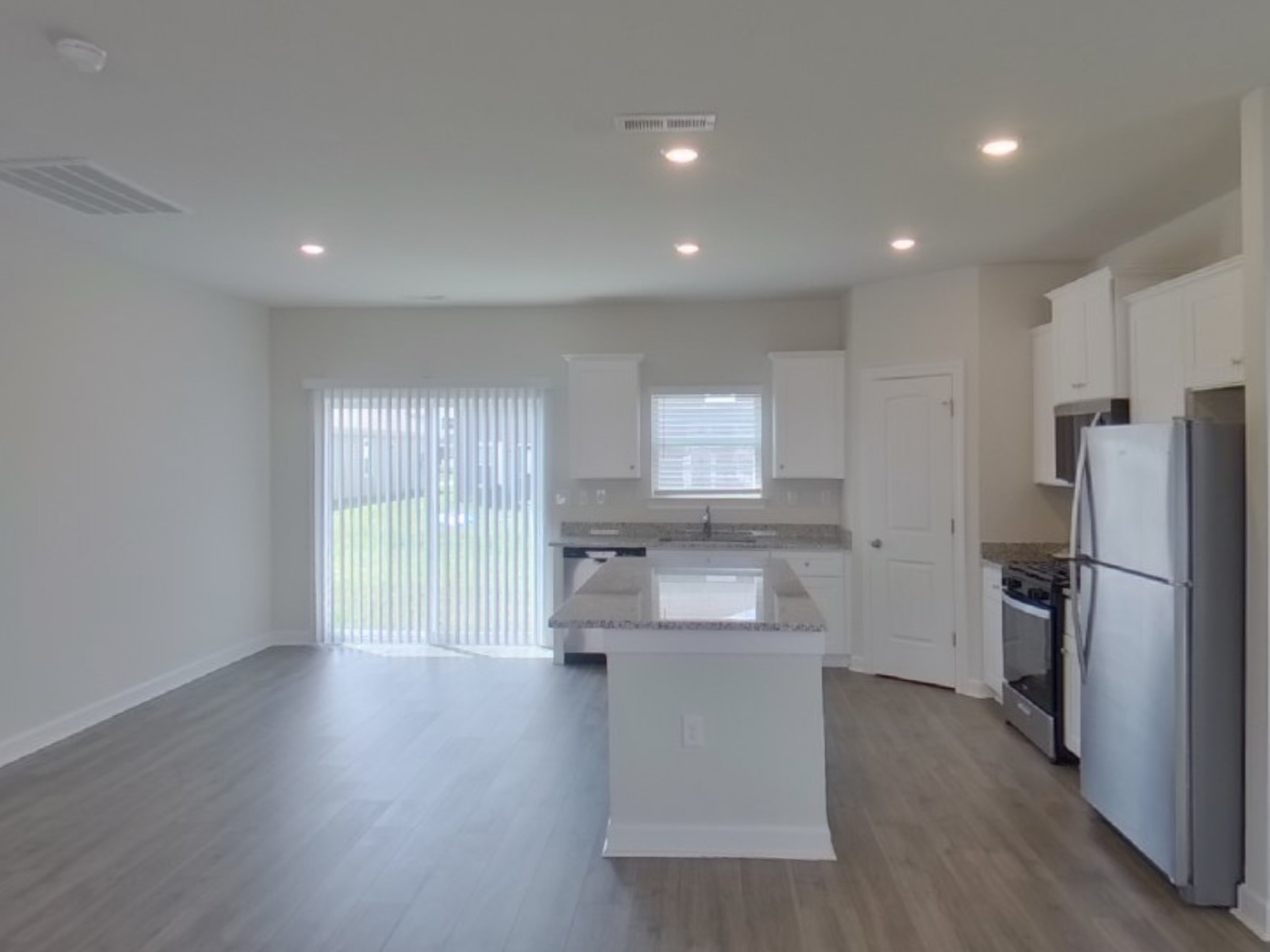 2410 Valverde Way Murfreesboro, TN 37127 - Photo 5 of 16 a kitchen with kitchen island white cabinets and stainless steel appliances