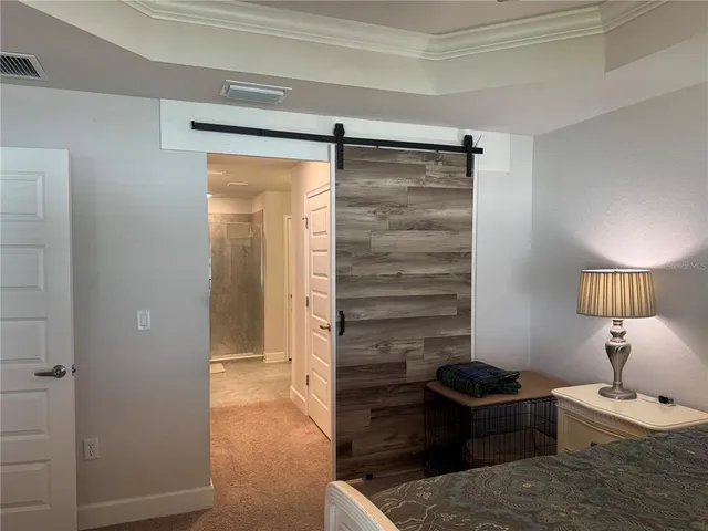 a bedroom with a bed and a mirror