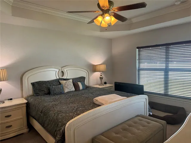 a bedroom with a bed and a chandelier