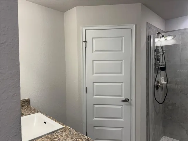a white toilet sitting next to a shower