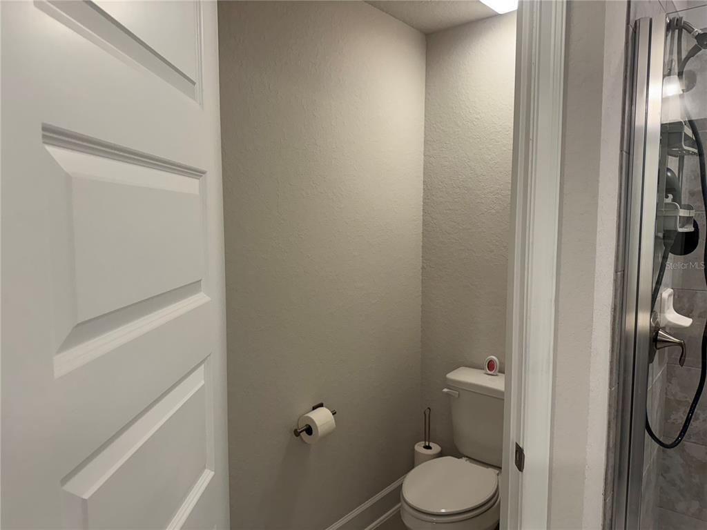 5123 Southwest 91st Street Ocala, FL 34476 - Photo 19 of 29 a white toilet sitting next to a shower