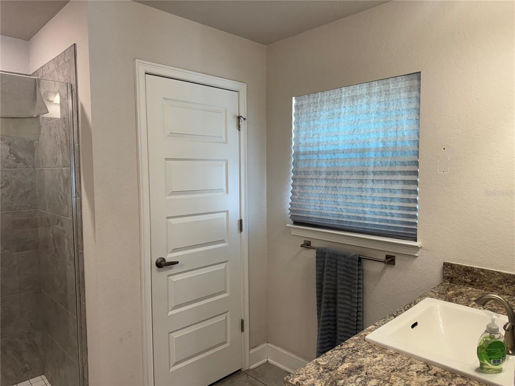 5123 Southwest 91st Street Ocala, FL 34476 - Photo 20 of 29 a room that has a bed and a window