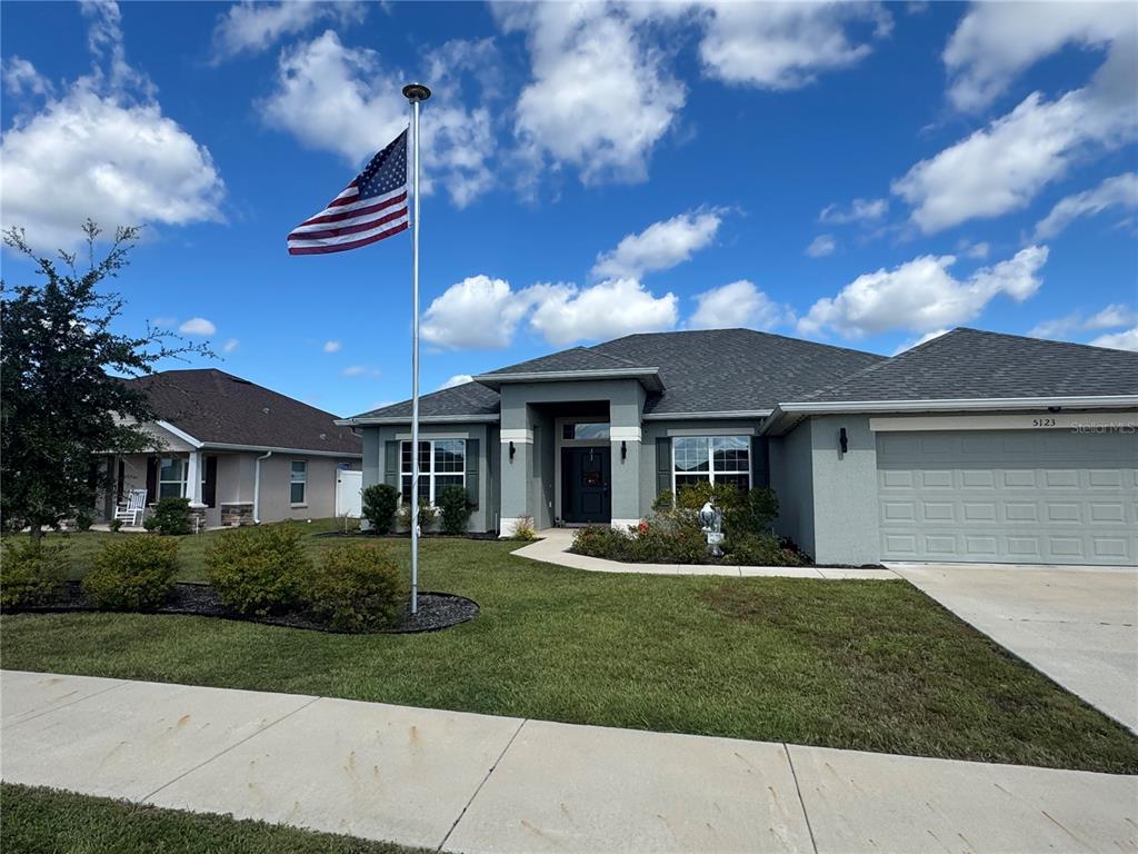 5123 Southwest 91st Street Ocala, FL 34476 - Photo 2 of 29 a front view of a house with a garden