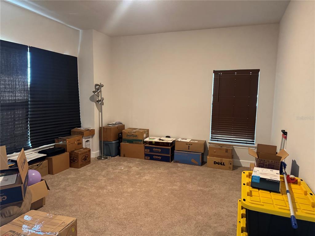 5123 Southwest 91st Street Ocala, FL 34476 - Photo 24 of 29 a bedroom with furniture and a flat screen tv