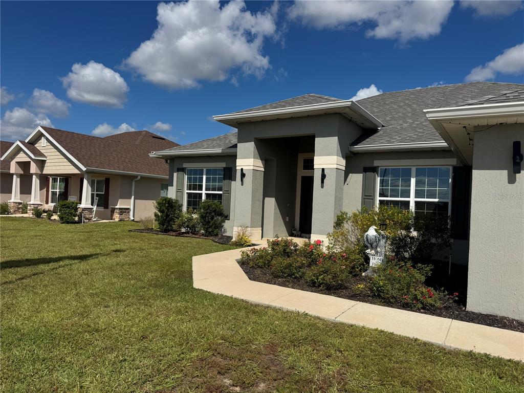 5123 Southwest 91st Street Ocala, FL 34476 - Photo 4 of 29 a front view of a house with a yard