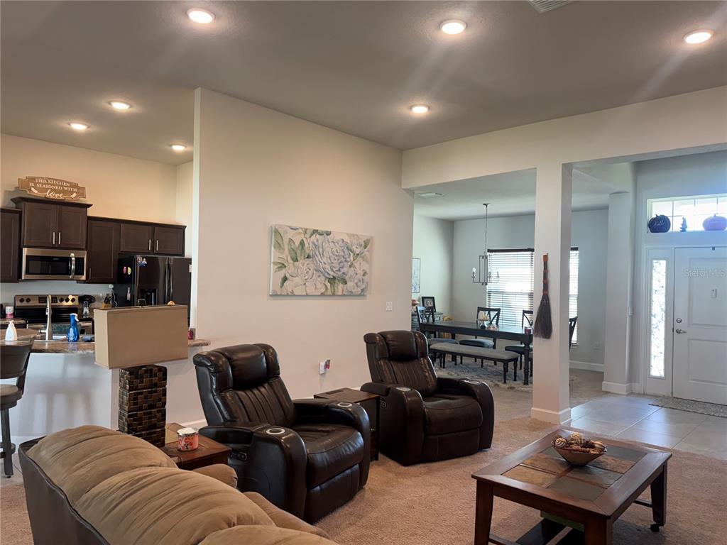 5123 Southwest 91st Street Ocala, FL 34476 - Photo 7 of 29 a living room with furniture and a flat screen tv