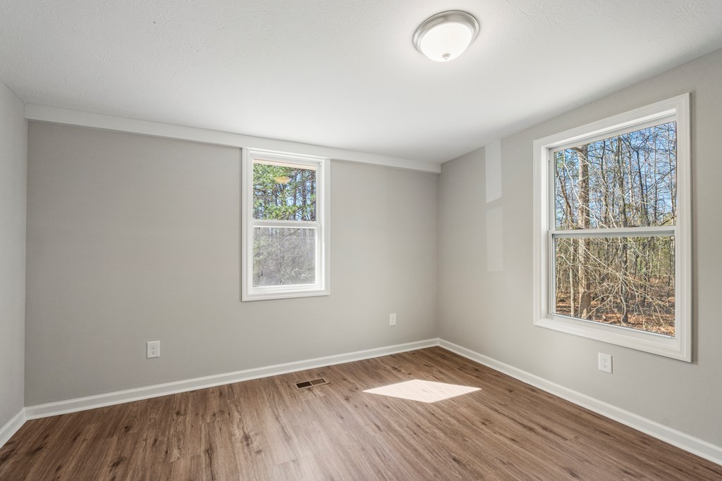 19110 Ga Highway Shiloh, GA 31826 - Photo 11 of 15 an empty room with wooden floor and windows