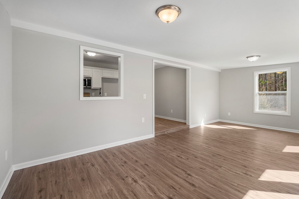 19110 Ga Highway Shiloh, GA 31826 - Photo 5 of 15 an empty room with wooden floor and windows