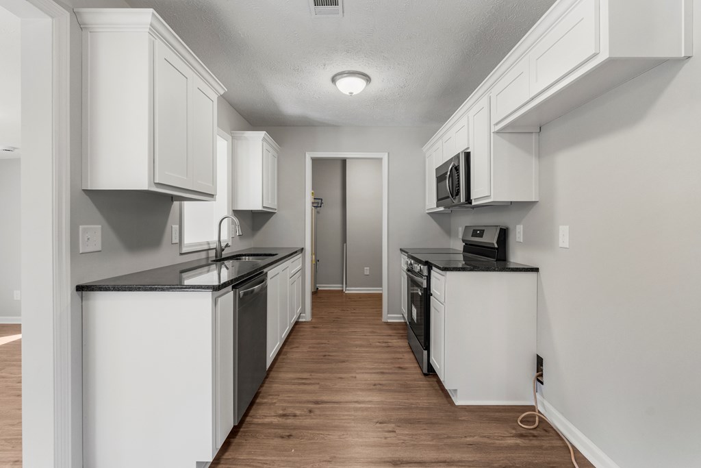 19110 Ga Highway Shiloh, GA 31826 - Photo 6 of 15 a kitchen with stainless steel appliances granite countertop a stove a sink and a refrigerator