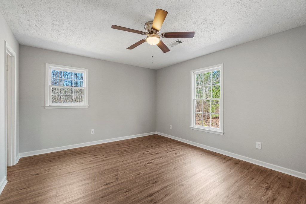 19110 Ga Highway Shiloh, GA 31826 - Photo 7 of 15 a view of an empty room with wooden floor and a window