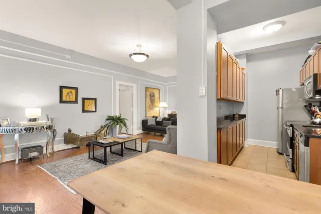 a kitchen with granite countertop a sink a stove and cabinets