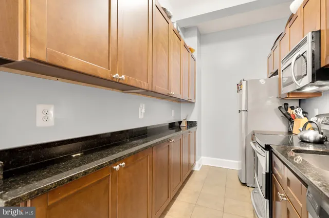 a kitchen with stainless steel appliances granite countertop a sink and stove