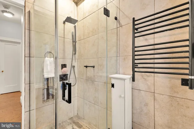 a bedroom with bed a table and painting on the wall