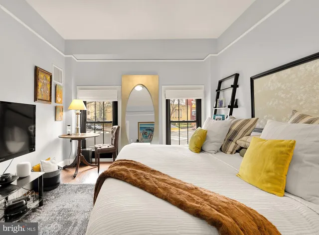 a bedroom with a bed and a lamp