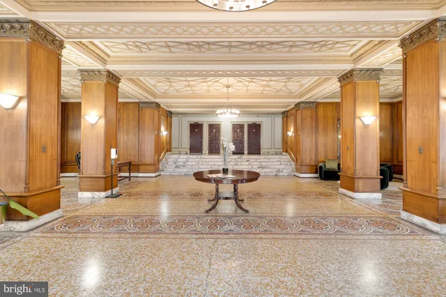 a lobby with furniture and a chandelier