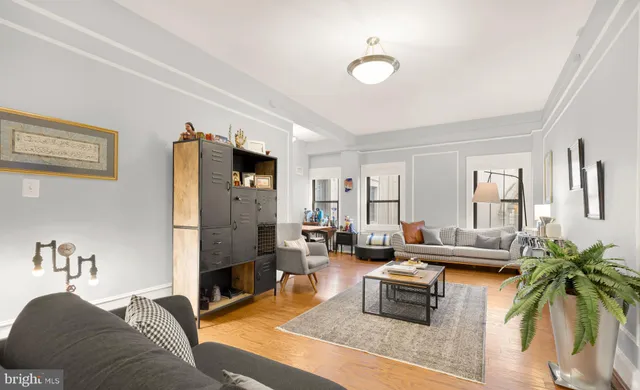 a living room with furniture fireplace and rug