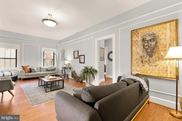 a living room with furniture fireplace and a window