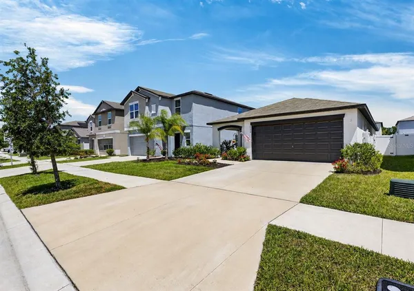 a front view of a house with a yard and garage