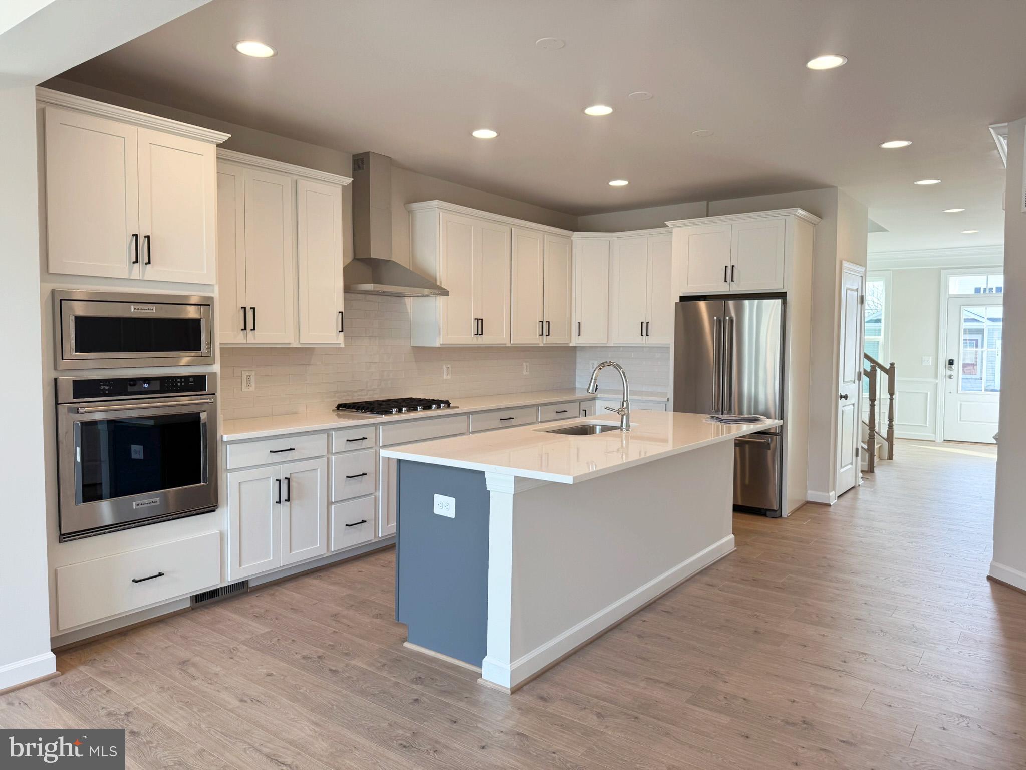115 Sapphire Street Stephenson, VA 22656 - Photo 11 of 36 a large kitchen with stainless steel appliances granite countertop a stove and a refrigerator