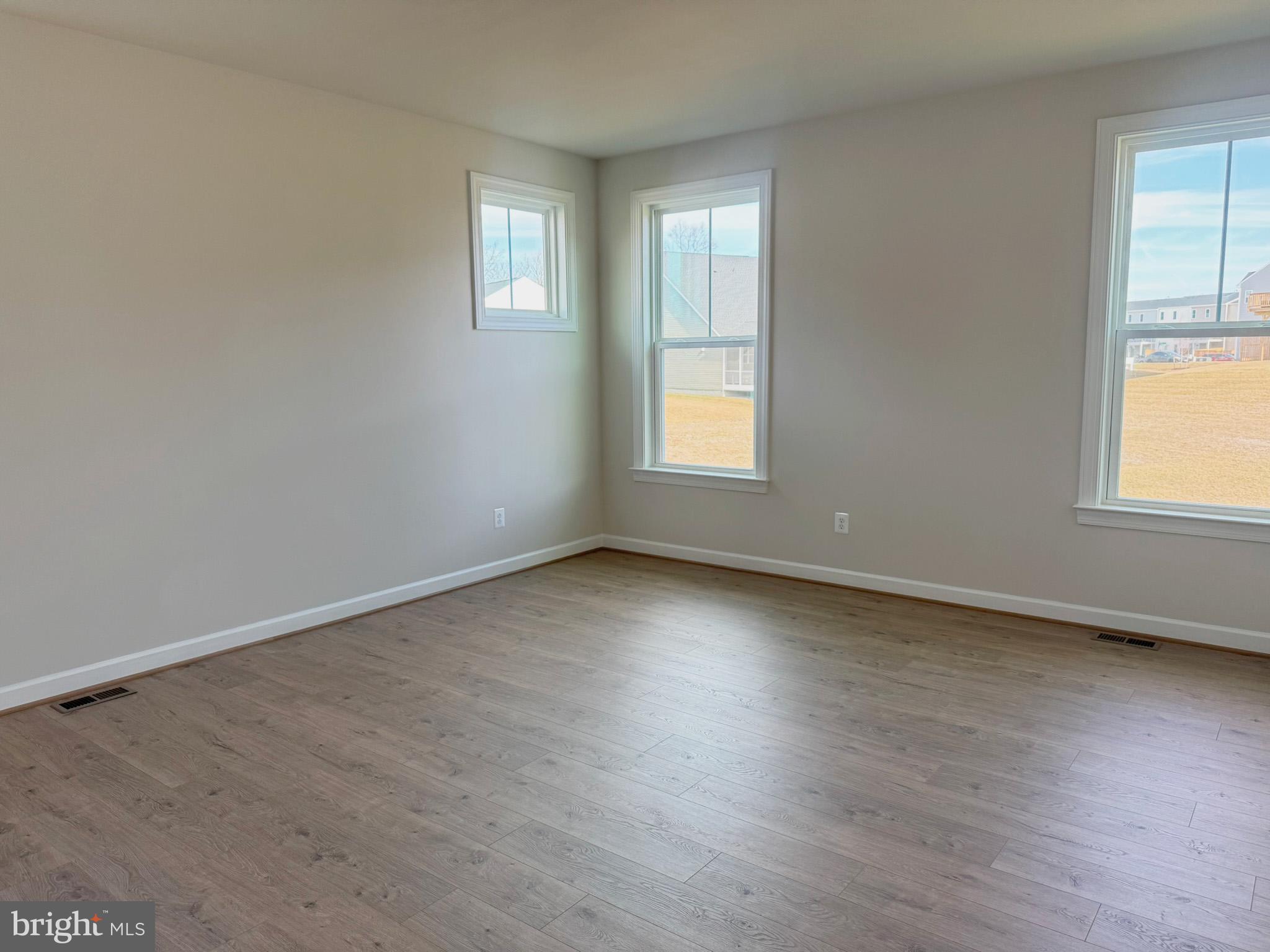 115 Sapphire Street Stephenson, VA 22656 - Photo 19 of 36 an empty room with wooden floor and windows