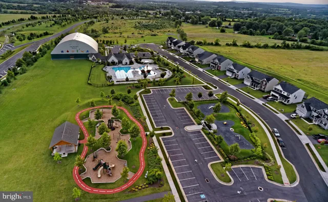 swimming pool view with a garden view