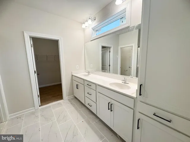 a bathroom with a double vanity sink and mirror