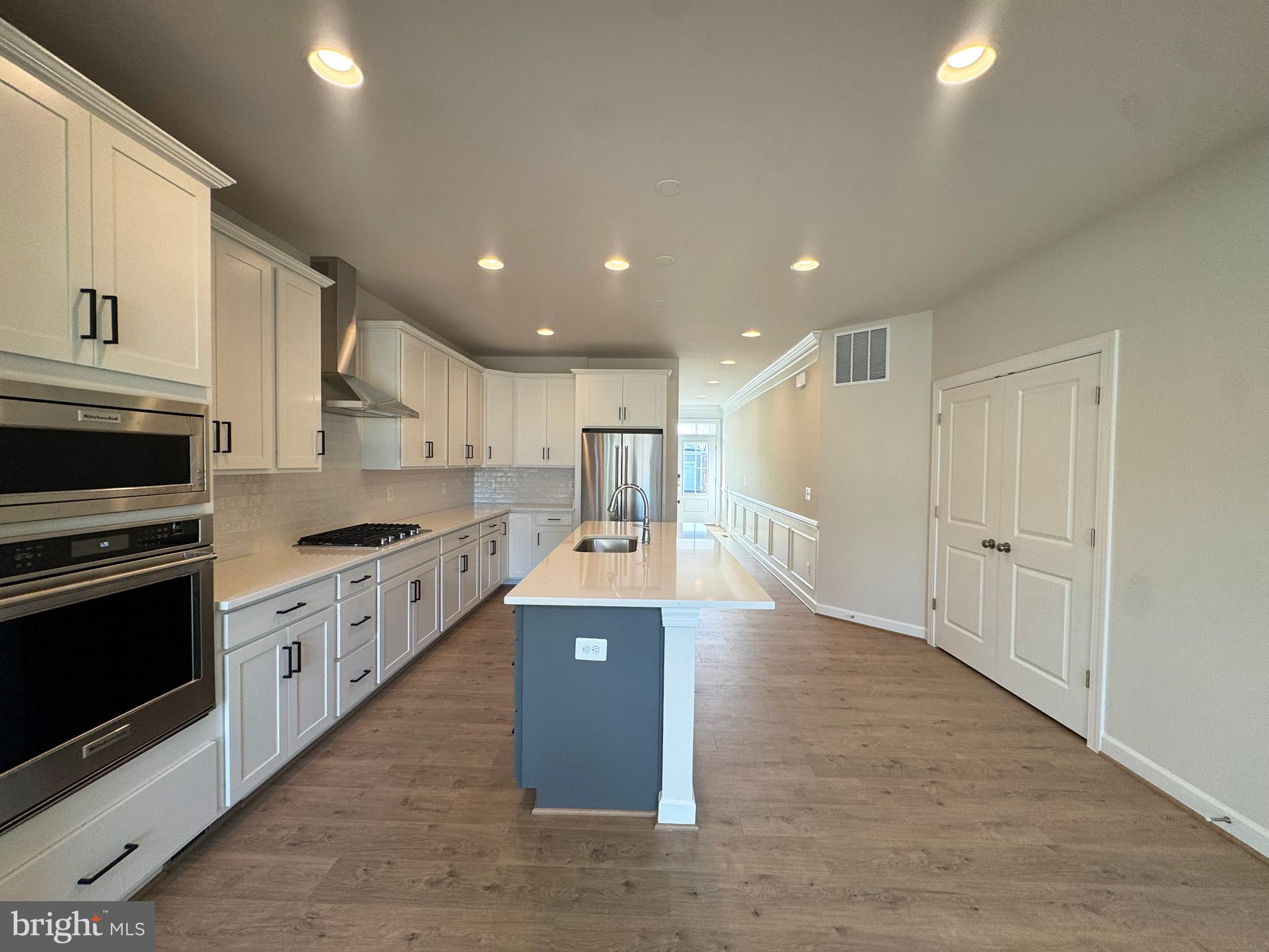 115 Sapphire Street Stephenson, VA 22656 - Photo 8 of 36 a large kitchen with stainless steel appliances granite countertop a large counter top and a stove top oven
