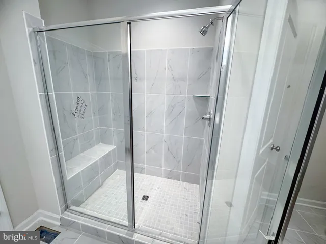 a bathroom with a glass door shower