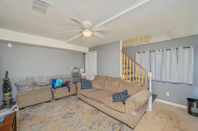 a living room with furniture and a rug