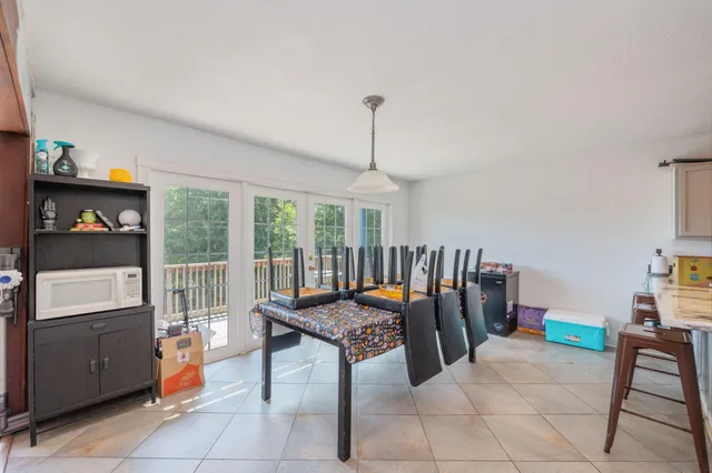 a dining room with furniture and gym equipment