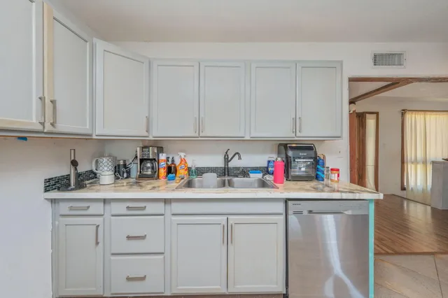 a kitchen with refrigerator and cabinets