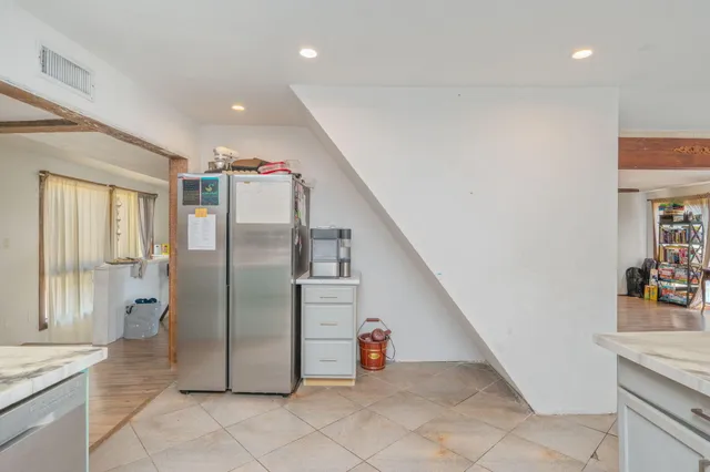 a kitchen with stainless steel appliances granite countertop a stove and cabinets