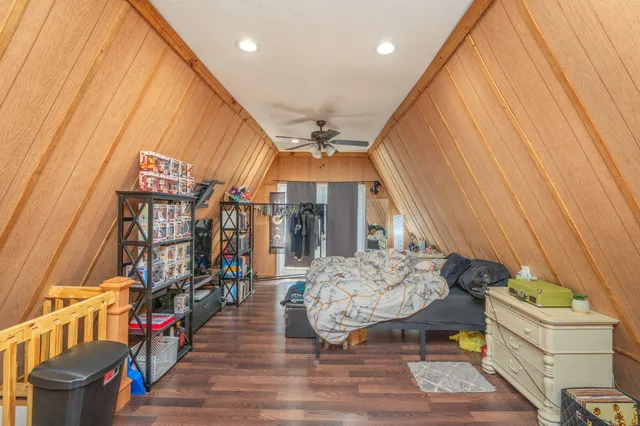a bedroom with bed and a chandelier
