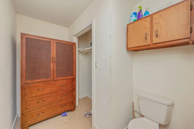 a view of walk in closet with living room
