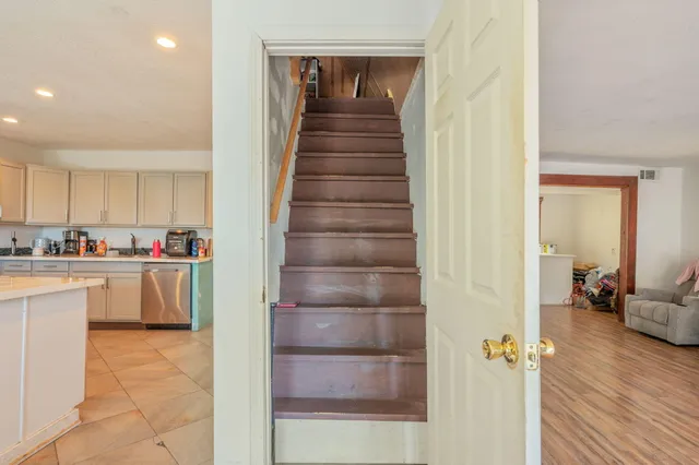 a bathroom with a toilet sink vanity and mirror