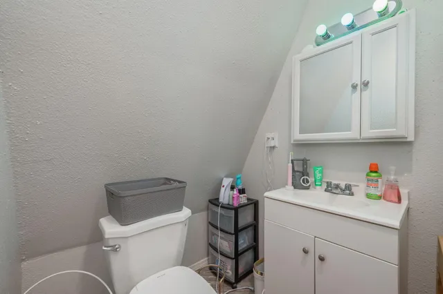 a bathroom with a sink a mirror and shower curtain
