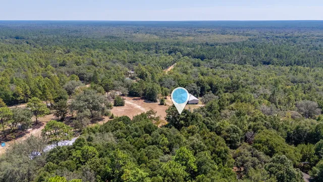 a view of a back yard of the house and green space