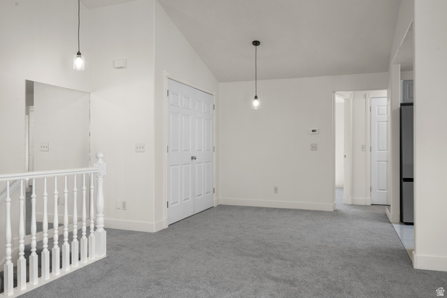 463 North 2400 West, Unit 7 Springville, UT 84663 - Photo 9 of 22 Vaulted ceilings, neutral gray carpet, white wall paint, classic white balusters, and contemporary pendant lighting