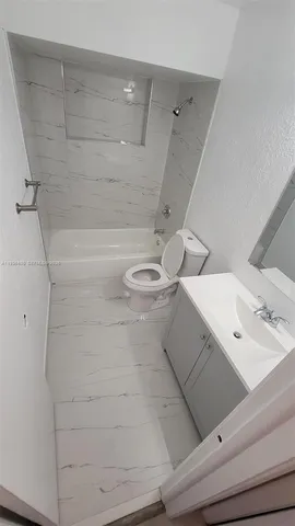 a bathroom with a bathtub and shower