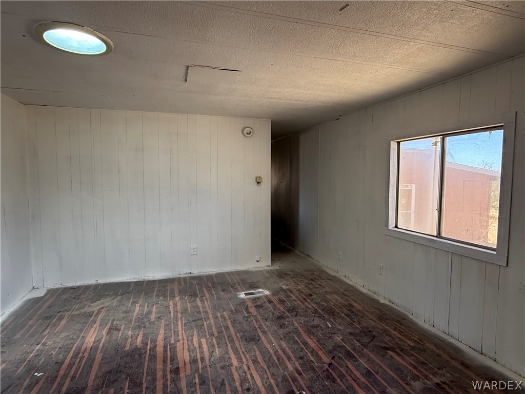8051 7th Street Dolan Springs, AZ 86441 - Photo 25 of 65 an empty room with wooden floor and windows