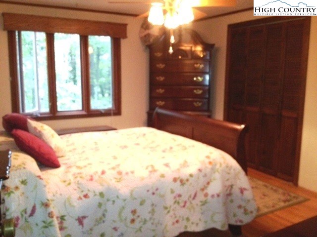 1292 Ben Miller Road Deep Gap, NC 28618 - Photo 18 of 31 a bed sitting in a bedroom next to a window