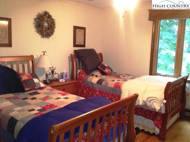 1292 Ben Miller Road Deep Gap, NC 28618 - Photo 20 of 31 a bed sitting in a bedroom next to a window