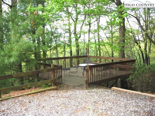 1292 Ben Miller Road Deep Gap, NC 28618 - Photo 24 of 31 a view of garden with wooden fence and trees in the background