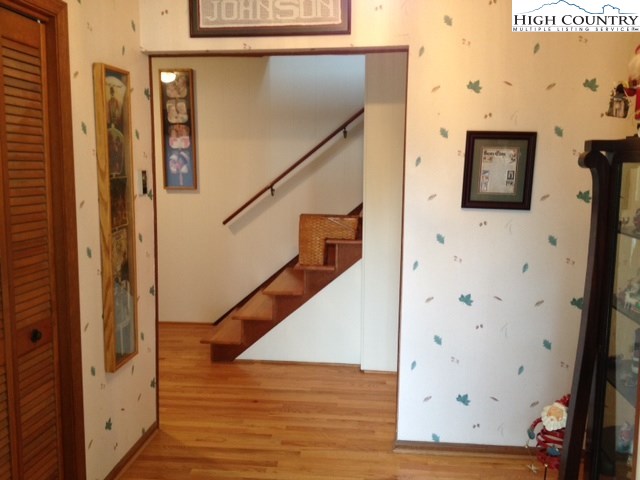 1292 Ben Miller Road Deep Gap, NC 28618 - Photo 4 of 31 a view of a hallway with wooden floor and staircase