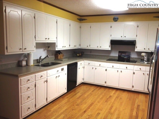 1292 Ben Miller Road Deep Gap, NC 28618 - Photo 7 of 31 a kitchen with granite countertop white cabinets and white appliances