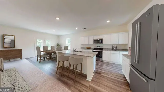 a bedroom with a large bed and a potted plant