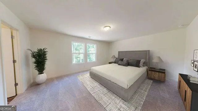 a bedroom with a large bed and a potted plant